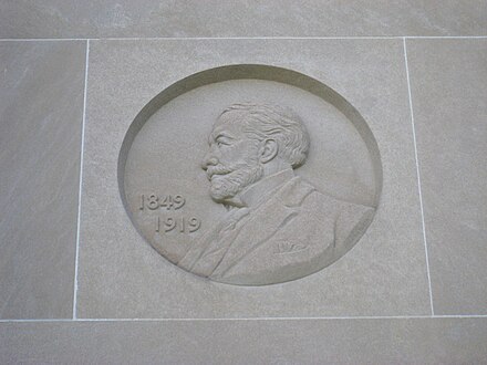 Henry Clay Frick portrait by Malvina Hoffman on the facade of the building