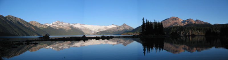 Panorama of Garibaldi Lake, with the Sphinx Glacier in the distance and the volcanoes of Mount Price and Clinker Peak at right. The Battleship Islands are in the foreground.