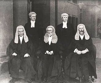 The first bench of the High Court: Barton, Griffith and O'Connor seated, with court officials in the background. Photo taken at the first sitting of the court on 6 October 1903. Hca bench and officials 1903.jpg