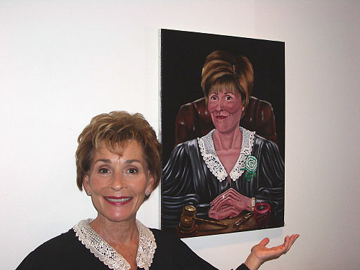Judge Judy next to painting