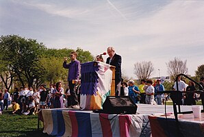 Marvin Liebman reading names at the AIDS Quilt podium, prior to the 1993 March on Washington for Lesbian, Gay, and Bi Equal Rights and Liberation. Liebman Reading Names at 1993 AIDS Quilt in DC.jpg