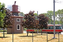 A streetcar passes by the Queen's Wharf Lighthouse. Fort York neighbourhood is served by 509 Harbourfront streetcar line. Lighthouse DSC00553 - Queen's Wharf Lighthouse (7603898804).jpg