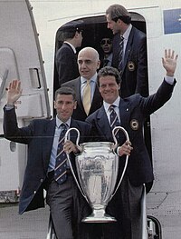 Tassotti (left) holds the UEFA Champions League trophy along with manager Fabio Capello, following Milan's victory in the 1993-94 edition of the tournament Mauro Tassotti, Fabio Capello and Adriano Galliani with the UEFA Champions League trophy - 1994.jpg