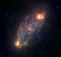 Mid-infrared view, combining the 3.6, 8.0 and 24 µm bands of the Spitzer Space Telescope