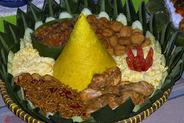 Tumpeng cone shaped rice surrounded with chicken, omelette eggs, sambel goreng ati (beef liver in sambal), potato perkedel, and tempeh orek. Tumpeng i