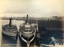 T.J. Potter in center, with smaller sidewheel steamer North Pacific on left, at Seattle, Washington, 1891 North Pacific and TJ Potter (steamboats), Seattle, 1891.JPG