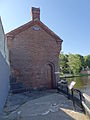 The entrance on the northwest side of the Pawtucket Gatehouse. The wall at the left is O'Donnell Bridge. Located near the the southeast end of the O'Donnell Bridge in Lowell, Massachusetts.