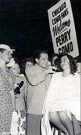 Arriving in Chicago for performances in 1947, Como is met by his fans, who get a hair trim along with a song.