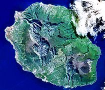Réunion from space (NASA image): The three cirques, forming a kind of three-leafed clover shape, are visible in the central north west of the image. Piton de la Fournaise is in the south east.