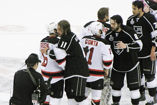 Kings and Devils players shake hands at the end of the game.