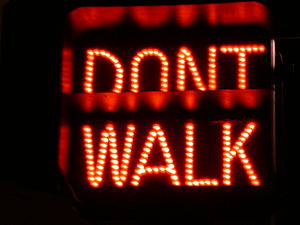 A signal displaying in red the text DON'T WALK