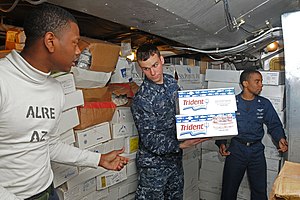 US Navy 120121-N-NB694-110 Sailors assigned to the Nimitz-class aircraft carrier USS Abraham Lincoln (CVN 72) put away supplies during a replenishm.jpg