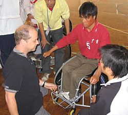 Wheelchair rugby classifier examining a new player Wheelchair rugby classification.jpg