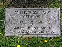 The footstone of William Wallace Denslow in Kensico Cemetery, featuring his seahorse insignia and images of the Scarecrow and Tin Woodman