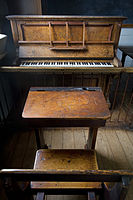 A 19th century classroom with wooden benches, a piano and a blackboard, Auckland, New Zealand