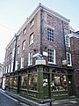 1 Minster Gates and 38 High Petergate. C15. Two shops and flat. Carving of Minerva. Grade II* listed.