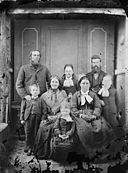 A group including, two men, two women and four children NLW3364825.jpg