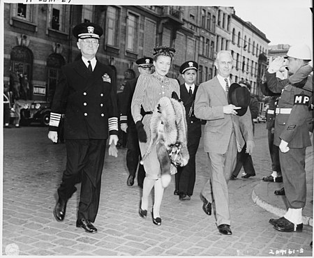 Adm. Harold Stark, and Ambassador to Belgium Charles Sawyer and Mrs. Sawyer, walk to the docks in Antwerp, Belgium to... - NARA - 198786.jpg