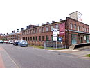 Vulcanized fiber factory, with administration building with entrance area, stamping hall, final production hall, wing with drying chambers and laboratories, winding machine hall, desalination hall, paper storage hall, social building with canteen and workshop, boiler house, hall complex on the water side, garage and company fire station, filter building and fencing of the factory premises on the street