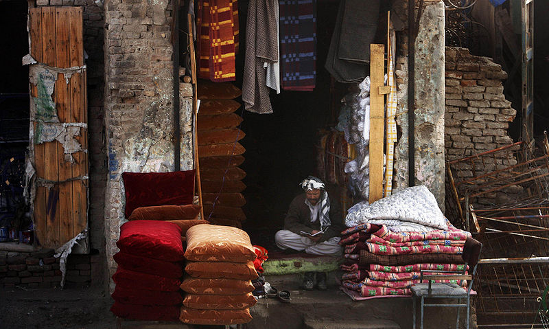 File:Afghan man outside his market stall 2-4-09.jpg