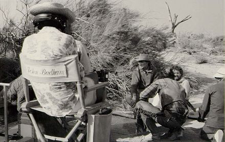 Film director John Badham during filming of The Godchild in 1974