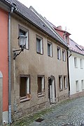 Residential house with back building (built over the Mühlgraben) and arched bridge, in closed development