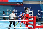 Deutsch: Boxen bei den Olympischen Jugendspielen 2018 Tag 12, 18. Oktober 2018 - Finale Fliegengewicht Mädchen – Martina La Piana (Italien, blau) schlägt Adijat Gbadamosi (Nigeria, rot) 5-0; Ringrichter ist James Beckles (Trinidad und Tobago). English: Boxing at the 2018 Summer Youth Olympics on 18 October 2018 – Girl's flyweight Gold Medal Bout - Martina La Piana (Italy, blue) beats Adijat Gbadamosi (Nigeria, red) 5-0; Referee is James Beckles (Trinidad and Tobago). Español: Boxeo en los Juegos Olímpicos Juveniles de Verano de 2018 en 18 de octubre de 2018 - Combate a medalla de oro de peso mosca para mujeres: Martina La Piana (Italia, azul) le gana a Adijat Gbadamosi (Nigeria, roja) 5-0; El árbitro es James Beckles (Trinidad y Tobago).