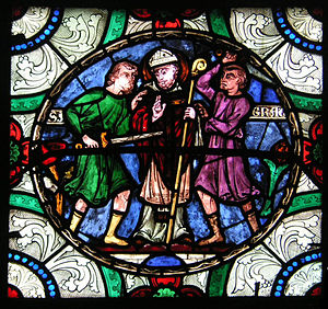 Stained glass image of three men. Mężczyzna w środku nosi mitrę i trzyma pastorał. Postać po lewej dzierży miecz wymierzony w brzuch środkowej postaci. Trzeci człowiek wznosi ręce.