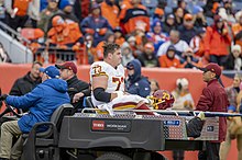 Roullier being carted off following a leg fracture, 2021 Chase Roullier carted off WFT vs Broncos OCT2021.jpg