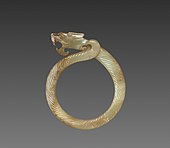 Fluted ring with a dragon head (huan); circa 475 BC; jade (nephrite); overall: 9.1 centimetres (3.6 in); Cleveland Museum of Art (Cleveland)