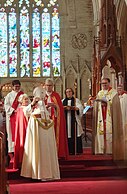 During the presentation of symbols of episcopal ministry, Sub-Dean Anne Wentzel places the mitre on Bishop Vanessa.