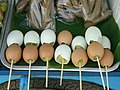 Cooked chicken eggs on a stick, seen in Thailand.