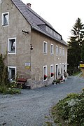 Residential mill house, two millstones in front of the house (Dammühle)