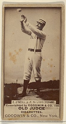 Standing man in baseball uniform catching a ball