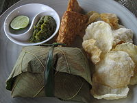 Example of Javanese cuisine. Clockwise: fried tempeh, mlinjo crackers, gudeg with rice wrapped in teak leaf, green chili sambal and sliced lime. Javanese Cuisine, Djogdja.jpg