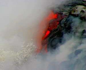 Pāhoehoe lava meets Pacific (close-up) still lots of smoke