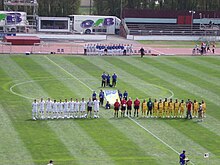 The Malaysian team (yellow) against New Zealand (white) during a friendly match in Queen Elizabeth II Park, Christchurch, New Zealand on 19 February 2006. NZvMalLineup1.JPG