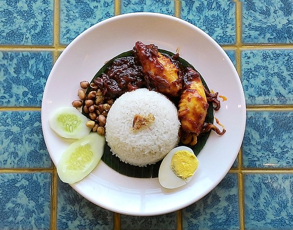 Nasi lemak: a versatile fragrant coconut rice dish served with various accompaniments, e.g. eggs (either done sunny side up or boiled), sambal sotong,