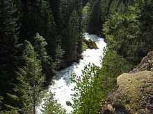 Looking down at the raging North Fork Nooksack River from the Mount Baker Highway, which, at this location, runs along a 200-foot cliff that drops almost straight into the river. This location is just upstream from Nooksack Falls.