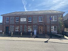 The front of Petersfield Museum and Art Gallery. The building is the Old Police Station made of flint and brickwork.