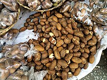 "Bitter kola nuts": seeds of Garcinia kola spread out for sale in the Dantokpa Market, Benin Petits colas exposes au marche Dantokpa Benin.jpg