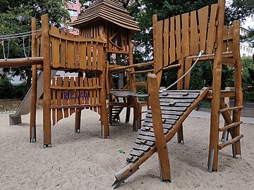 A climbing_slope (handrail=yes, material=wood) leading up to a platform/structure with a wobble_bridge and other connected devices.