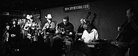 Gill (center, seated and playing guitar) with the Time Jumpers in 2011. Station Inn.jpg