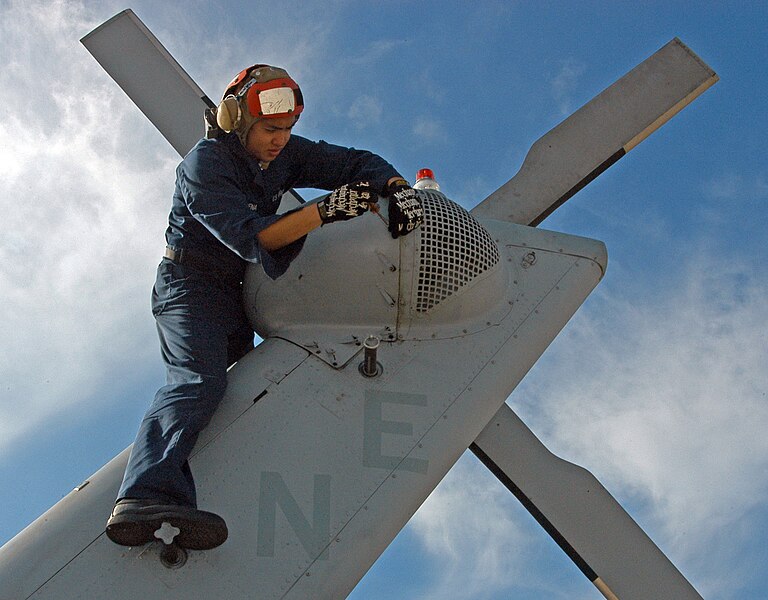 File:US Navy 060302-N-2832L-017 Storekeeper Seaman Eric Carpena, a plane captain assigned to Helicopter Anti-Submarine Squadron Two (HS-2), installs a tail gearbox.jpg