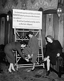 Publicity stunt at a 1955 screening of The Barefoot Contessa at the Tuschinski Theatre, Amsterdam; the first twenty ladies who left their shoes in the cloakroom at the theatre would receive free Max Factor products. 03-26-1955 13191 Tuschinski (4072261132).jpg