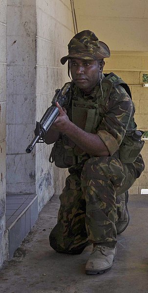 A PNGDF soldier in Kumul uniform with an M16 rifle