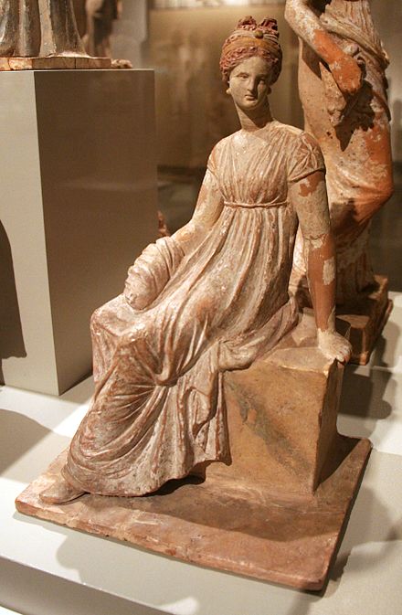 Tanagra figurine representing woman sitting