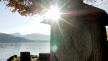 Sun rays hit Jung's mystical cuboid stone at Zurich lake Anima Jungiana.png