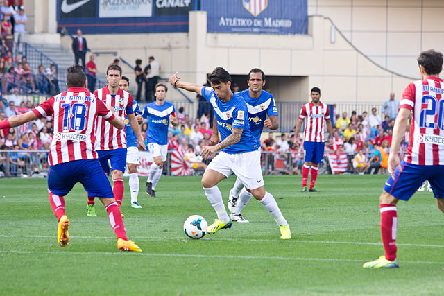 Suso (center) playing for Almería against Atlético Madrid in September 2013