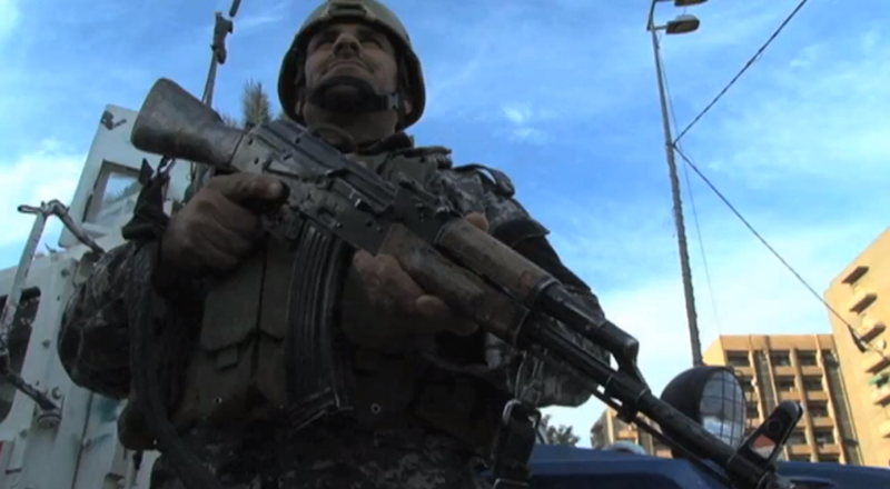 File:Baghdad Iraq during the post withdrawal insurgency soldier standing guard.png